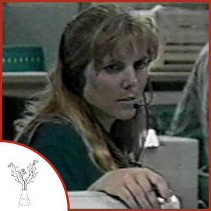 A screenshot of old footage featuring Jennifer Trosper. She is standing behind a computer in mission control, wearing a headset. The podcast logo is on the lower left.