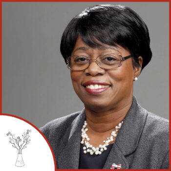 A formal photo of Wanda Austin. The podcast logo is on the lower left.